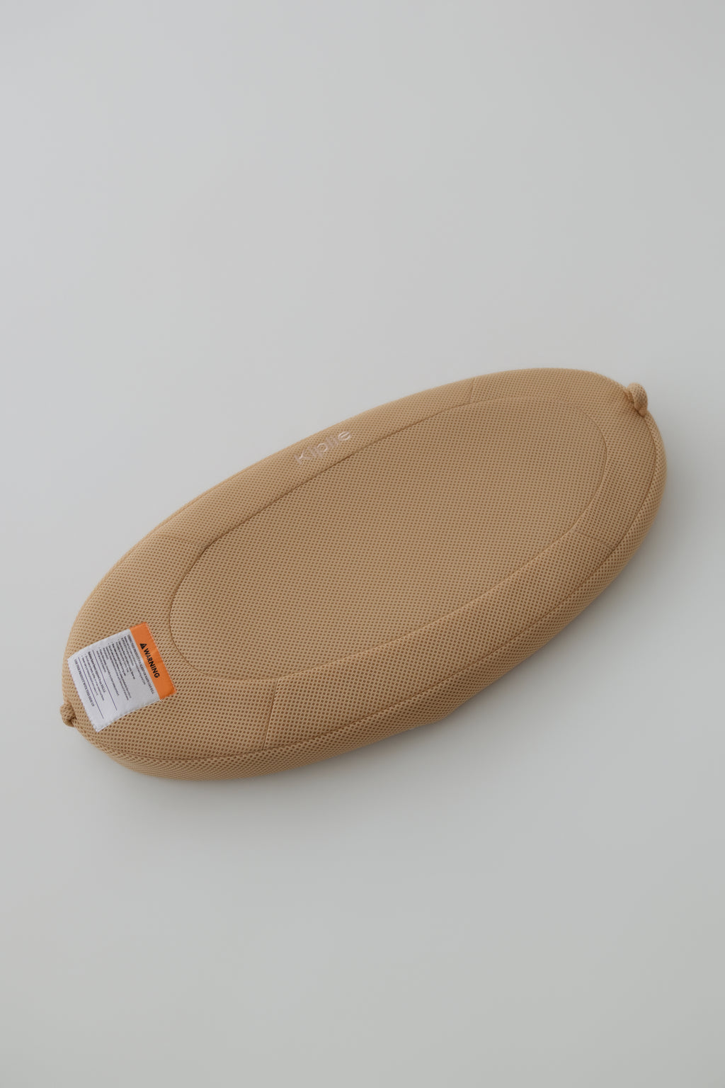 Travel Changing Pad in Sand set up for a diaper change on the go