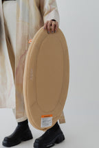 Baby on the Travel Changing Pad in Sand during supervised tummy time