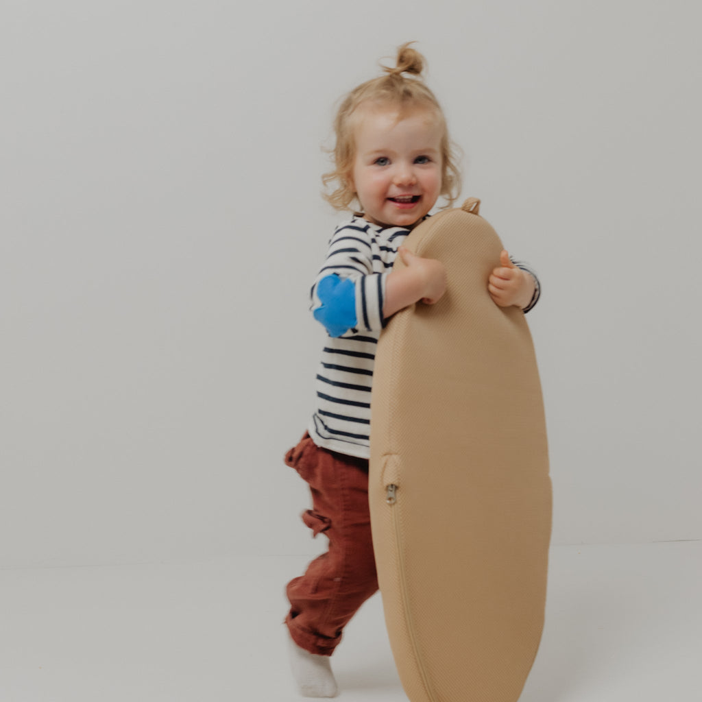 Travel Changing Pad in Sand folded and packed inside a diaper bag for travel