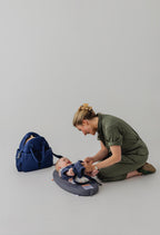 Kiplie gray baby changing mat folded showing compact travel size